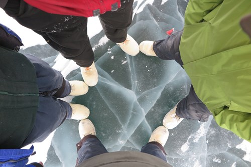 Boots on ice on the frozen surface of Teshekpuk Lake
